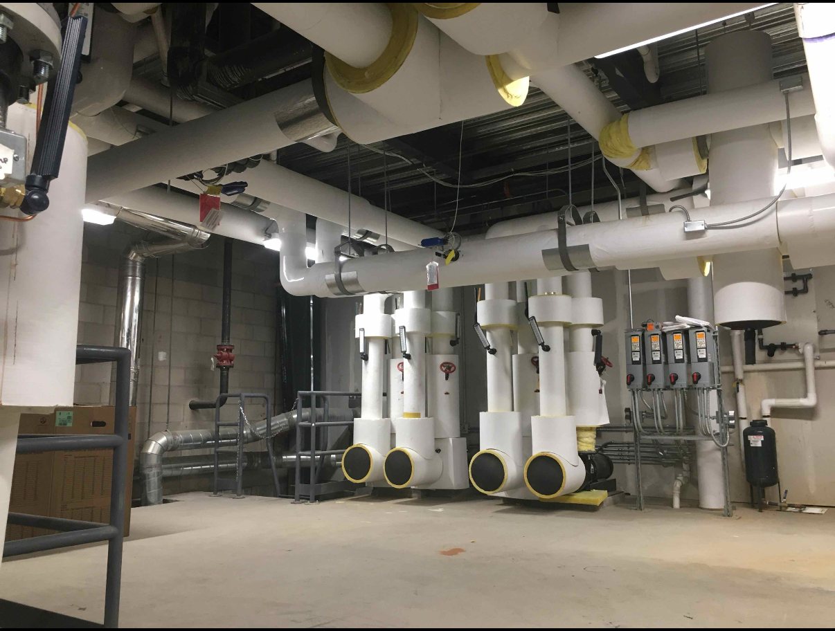 Wide mechanical infrastructure view with ductwork and utility routing.