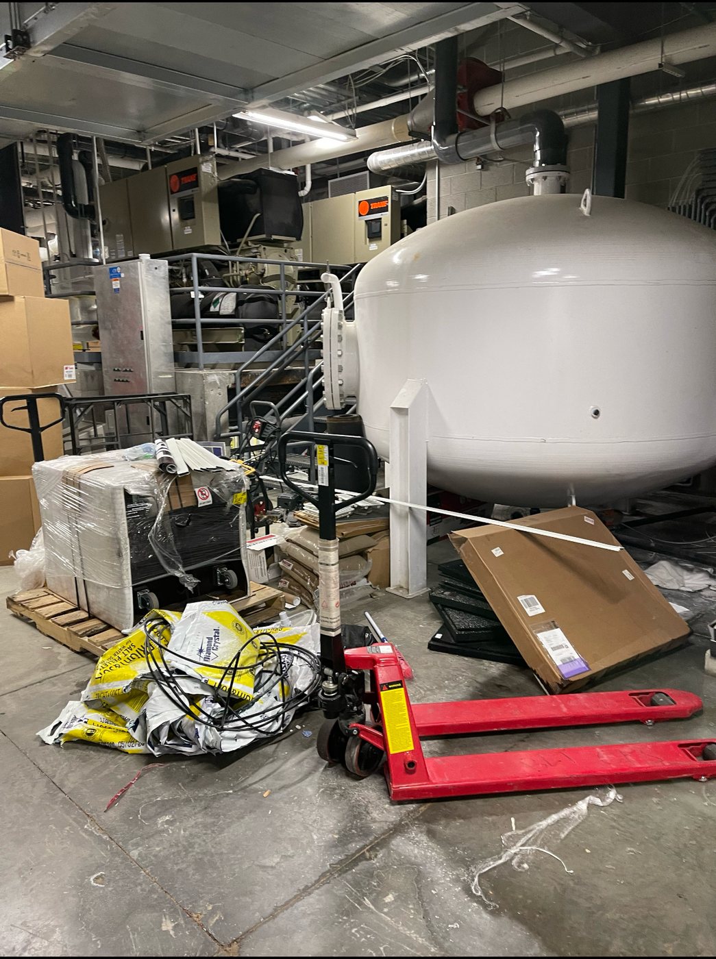 Equipment room tank area during active construction and material staging.